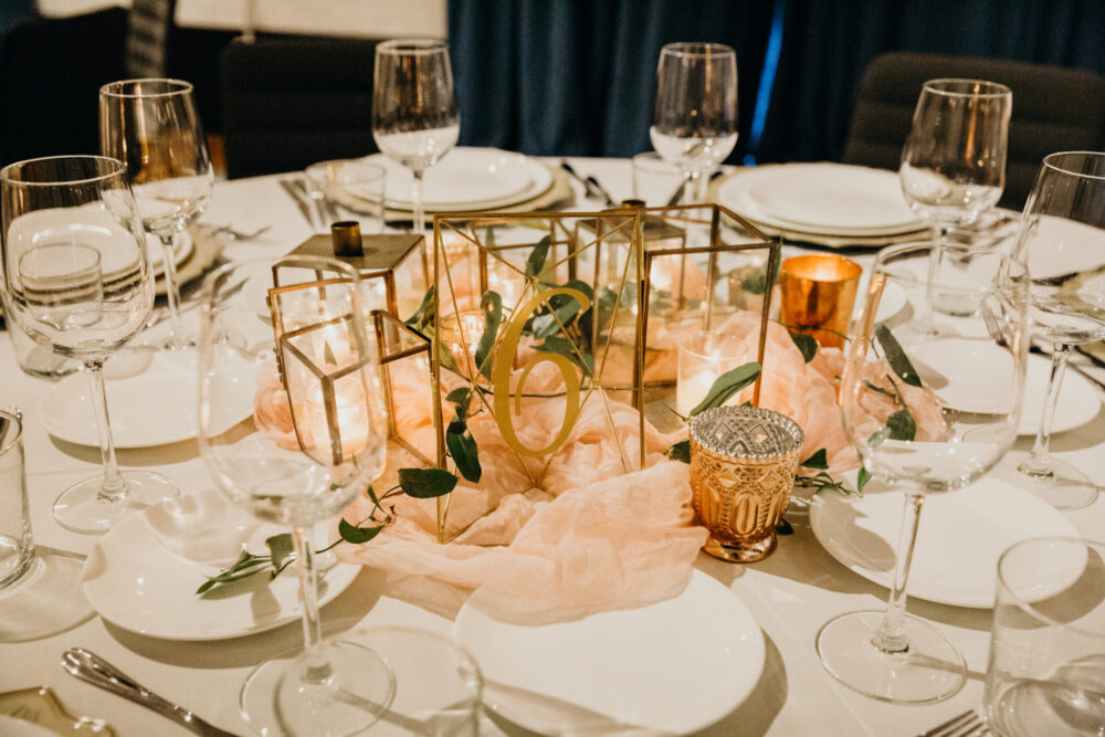 Table with glasses and a centerpiece at our Alexandria wedding venue
