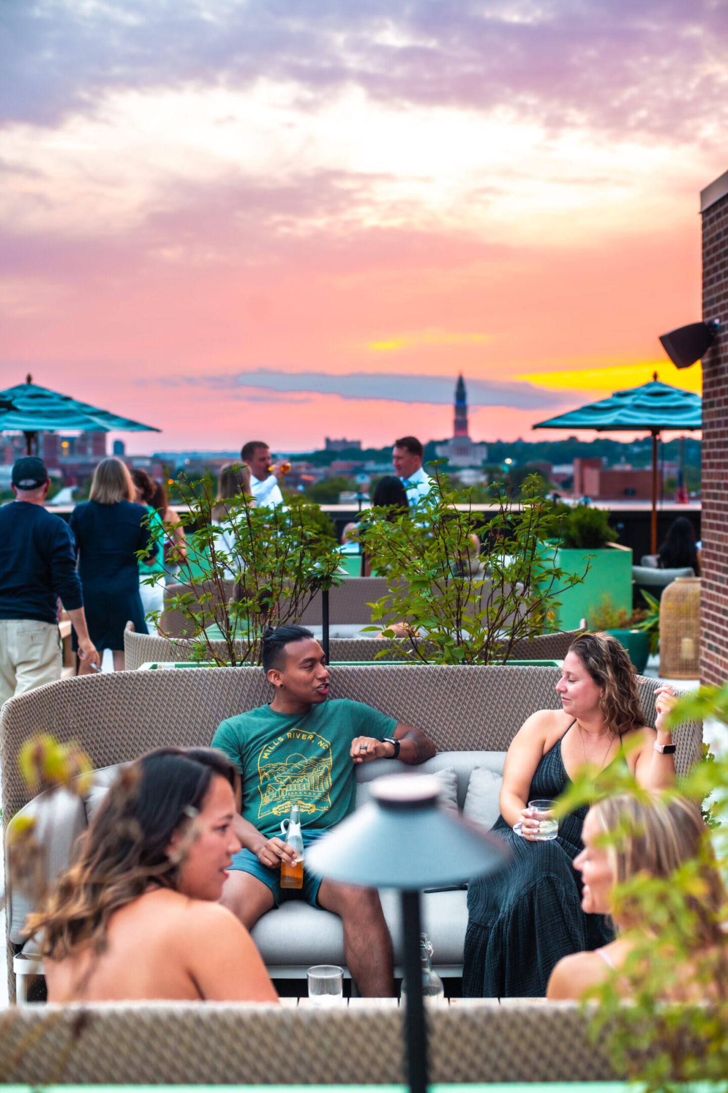 Group at Table eating with city in background